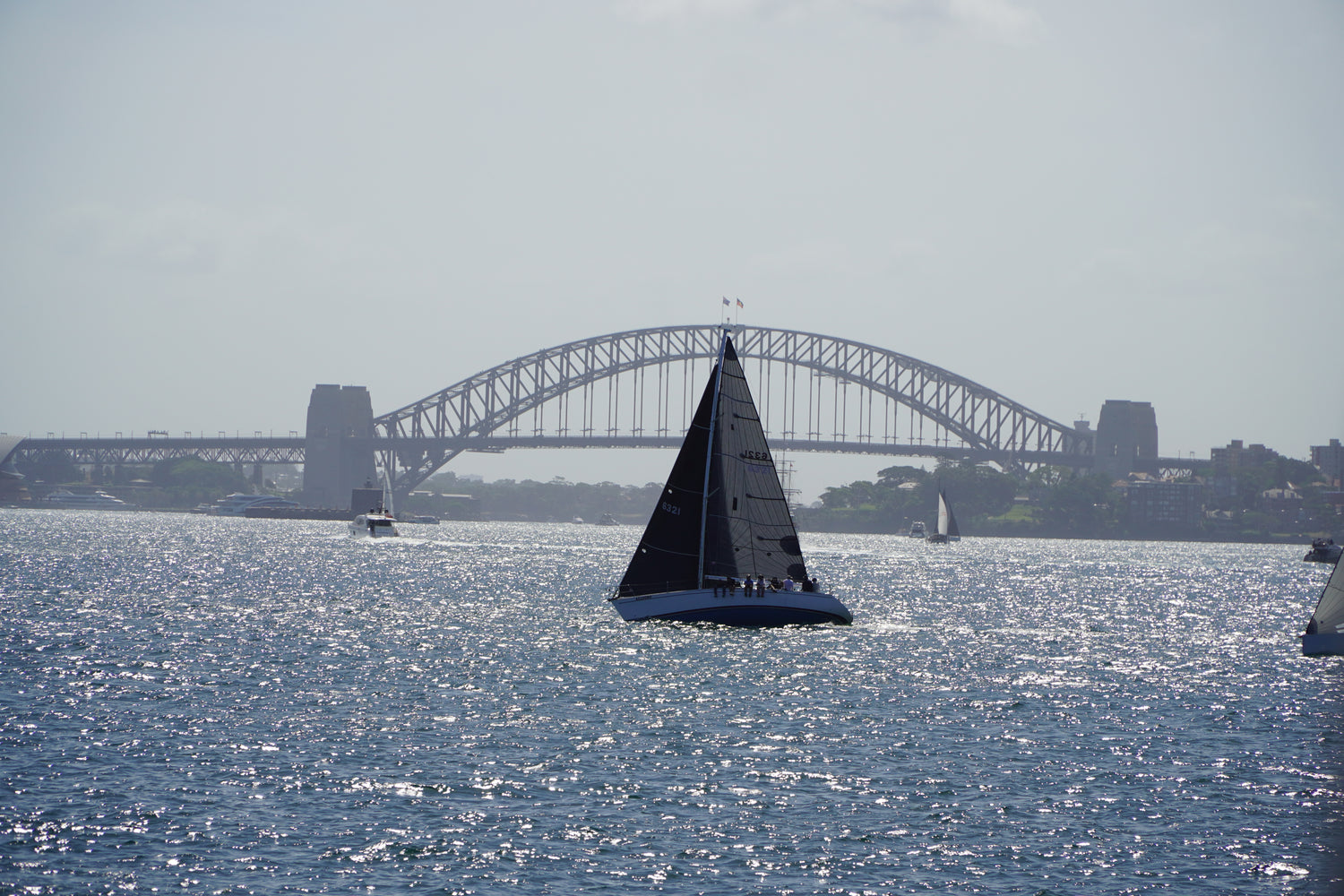 Yacht racing past the Sydney Harbour Bridge on Sydney Harbour